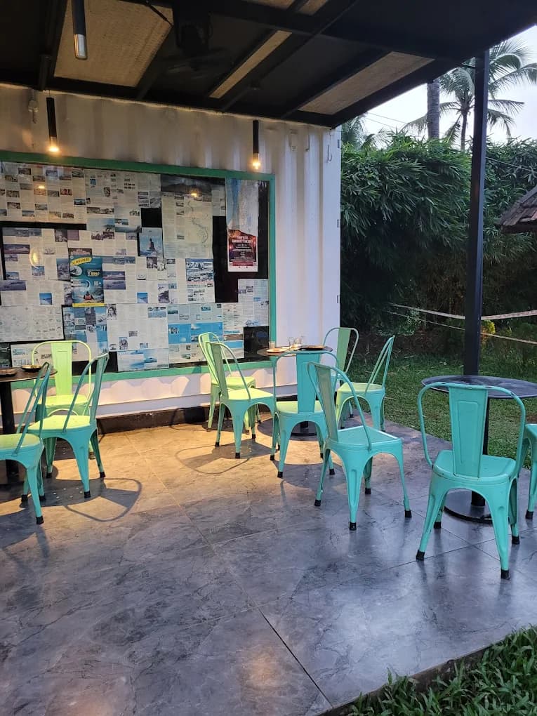 Night view of outdoor dining at River Queen, the premier lakeside cafe in Puttur