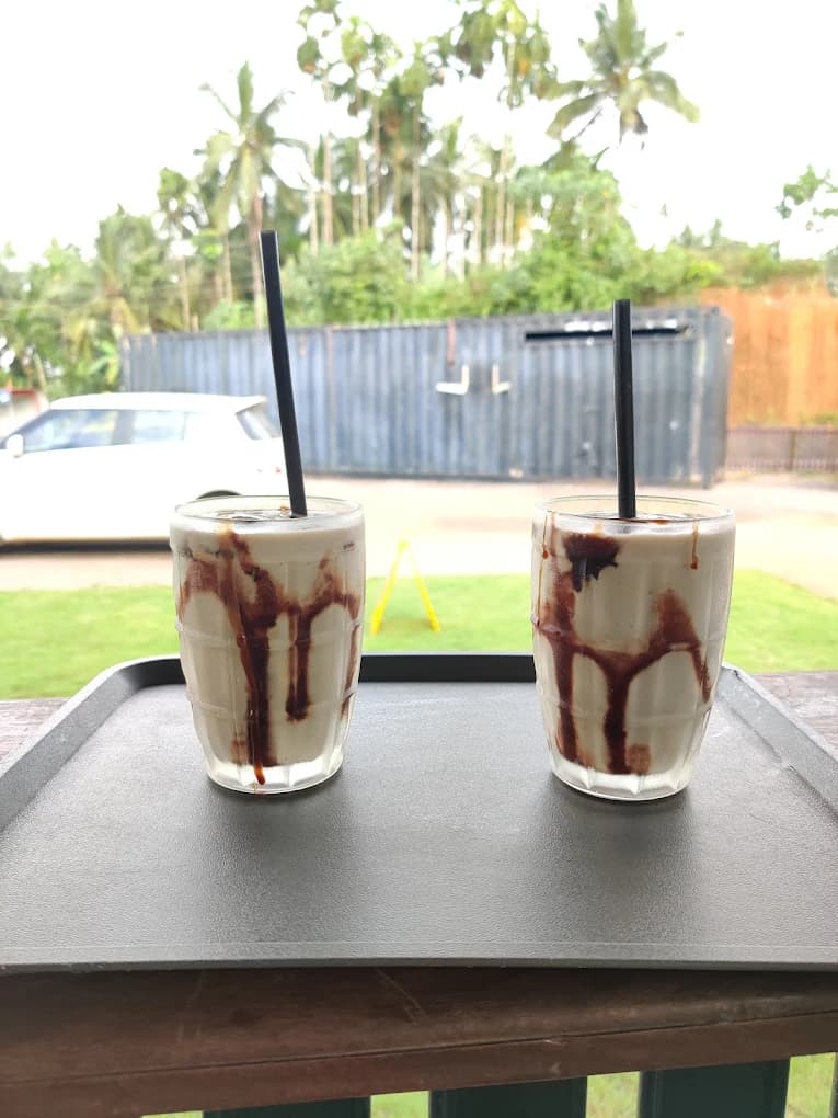 Premium Chikkoo milkshake beverages at River Queen lakeside cafe Shantimogaru