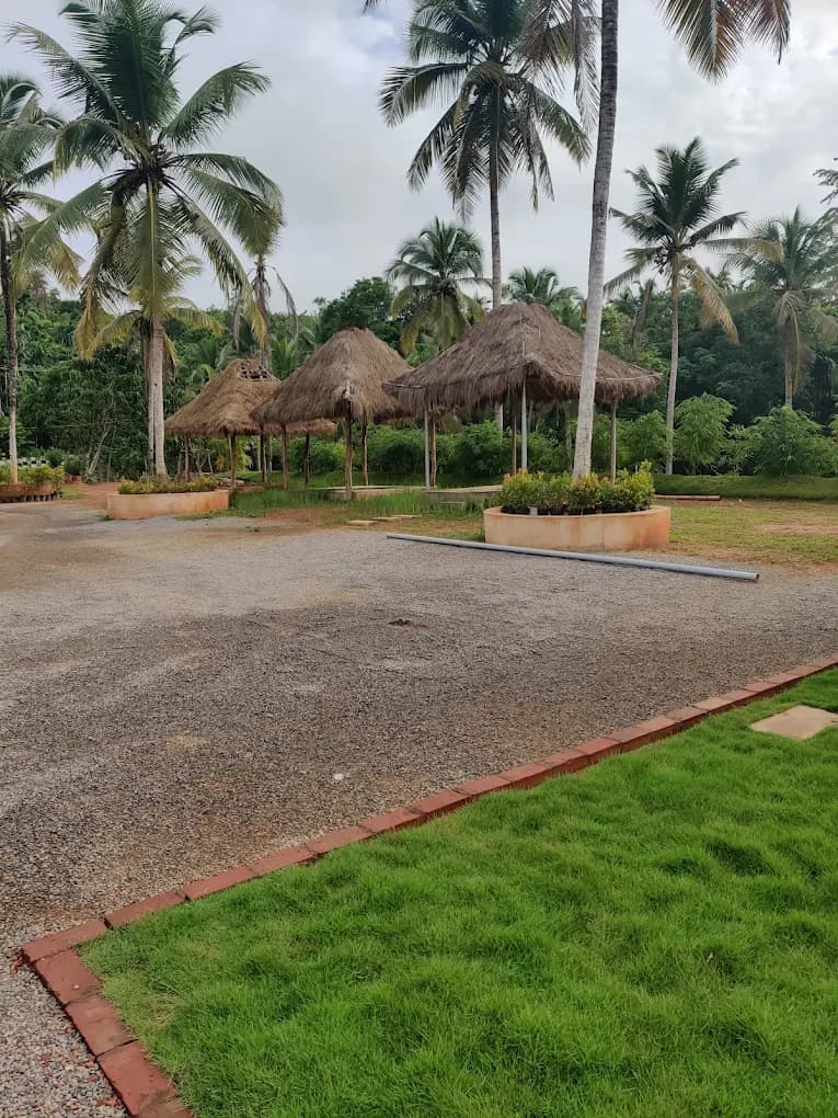 Outdoor balcony seating with nature views at River Queen cafe Shantimogaru