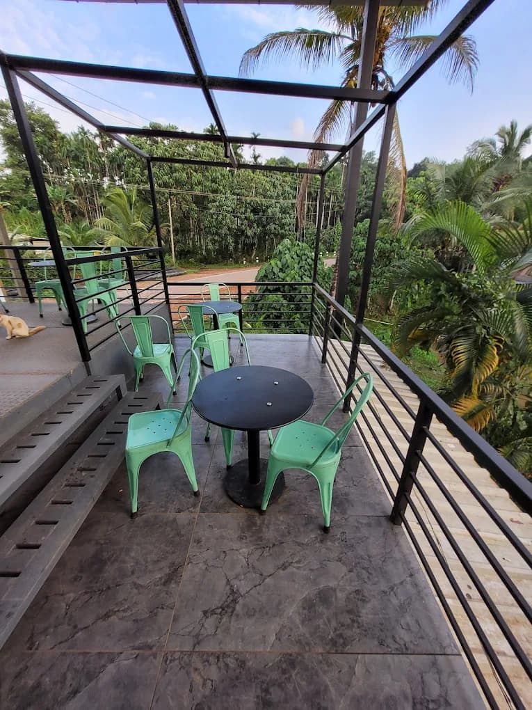 Rooftop seating with nature view at River Queen - the best cafe in Puttur